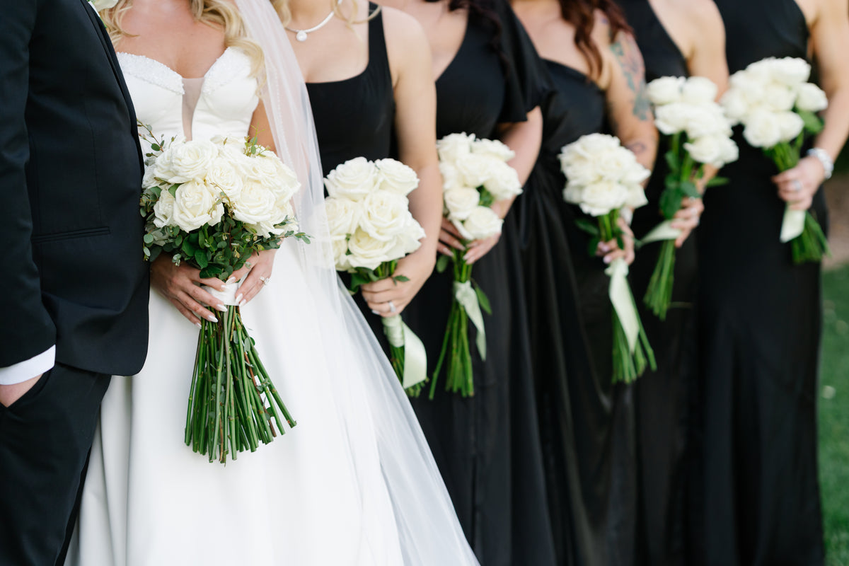white bridal bouquets held by bride and bridesmaids