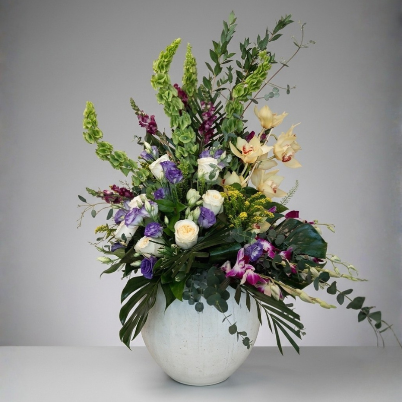 Fresh orchid and snapdragon stems selected for a flower bar